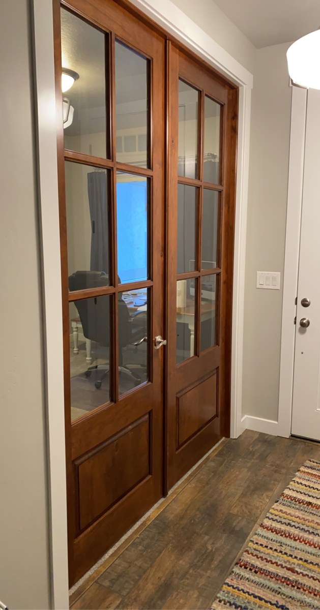 Paired wood French doors with divided glass panels